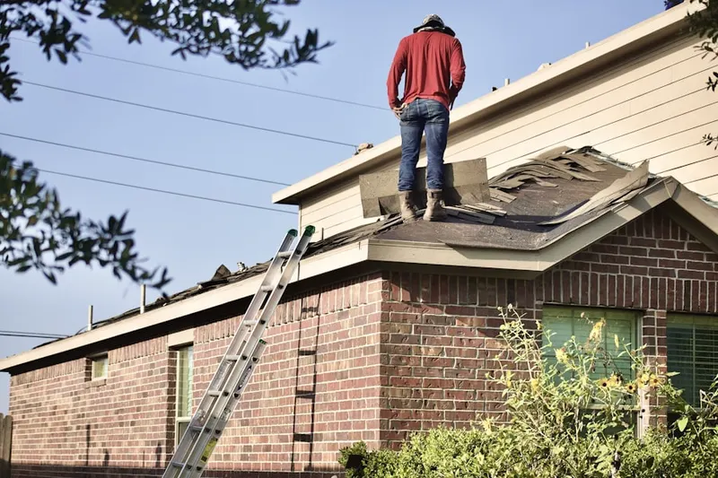 Professional roofer working on a residential roof in Klinesville